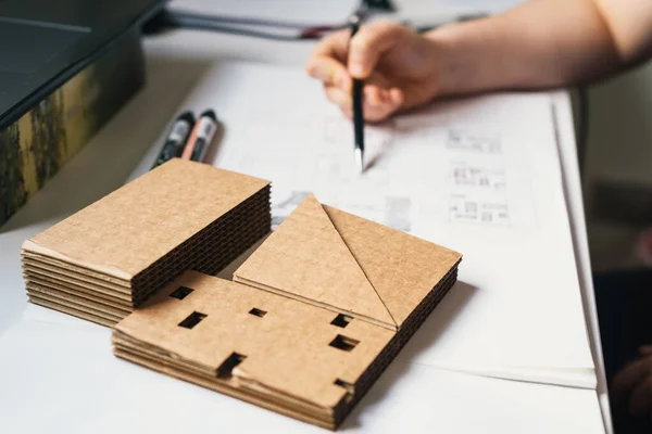 Arkitekt Skrivbord Med Kartong Arkitektonisk Modell och Arkitekt Hand Ritning Skisser. Selektiv inriktning — Stockfoto
