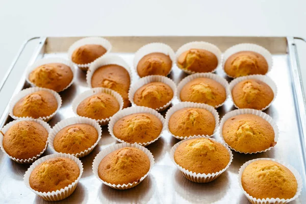 Homemade muffins on oven tray. Delicious pastries for dessert — Stock Photo, Image