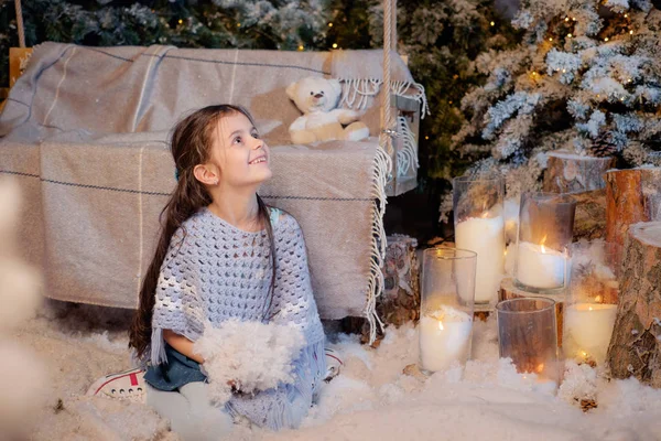 Little girl playing near the christmas tree — Stock Photo, Image