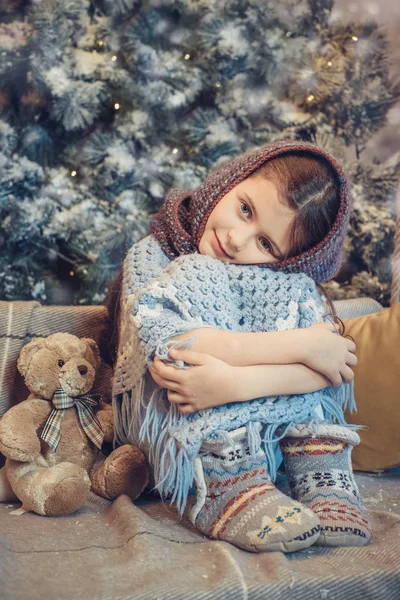 Cute little girl covered in warm scarf waiting for Christmas — Stock Photo, Image