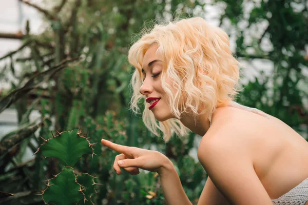 Portrait of playful female model at greenhouse — Stock Photo, Image