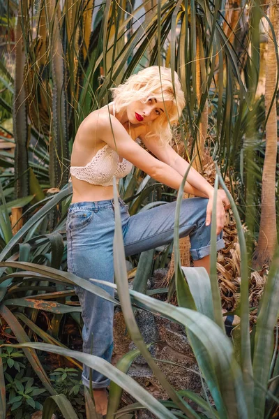 Portrait of seductive female fashion model posing at greenhouse — Stock Photo, Image