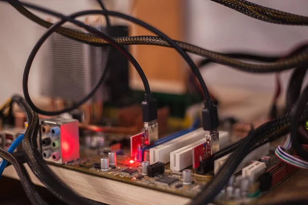 Video cards with on shelves connected to a farm for obtaining electronic money. Close-up. Out of focus. Blur