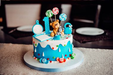 Üzerinde çiçekler olan beyaz düğün pastası yakın plan. Pasta rafında pasta var. beyaz süt kreması. Pembe ve mor çiçeklerle süslenmiş pasta