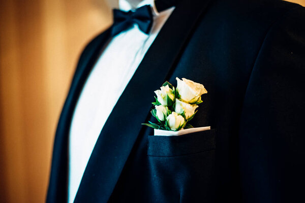 Hands of wedding groom getting ready in suit