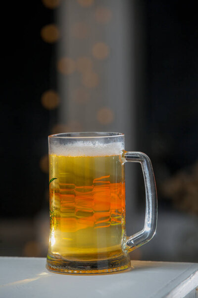 Mug of beer on wooden background