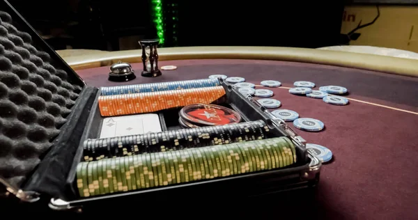 Burgundy casino table. High contrast image of casino roulette and poker chips