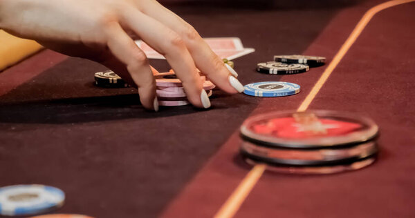 Burgundy casino table. High contrast image of casino roulette and poker chips