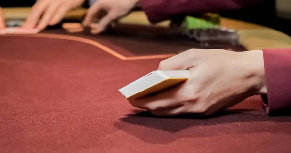 Dealer Sitting Casino Table While Holding Distributing Cards — Stock Photo, Image