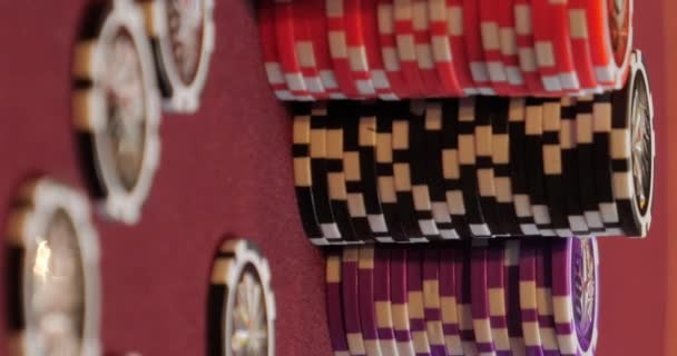 Playing poker. Woman is nervous, fingering the chips in her hand on the poker table. Hand close up. Casino gamble. — Stock Video