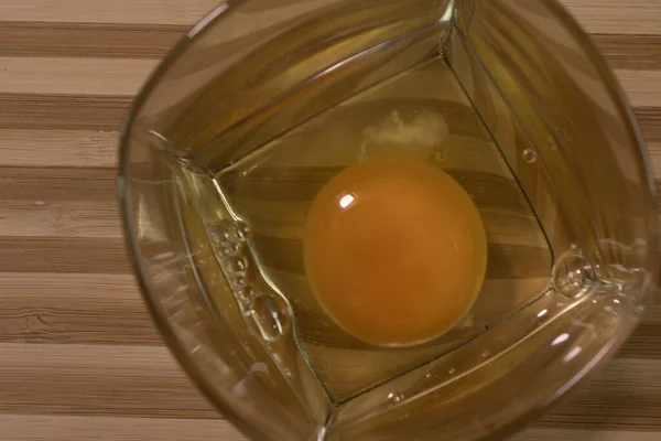 Uovo Crudo Bicchiere Vetro Sulla Scrivania Una Tavola Strisce — Foto Stock