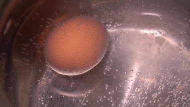 Tavuk yumurtası haşlanmış suda gaz ocağında küçük bir tavada kaynatılır.