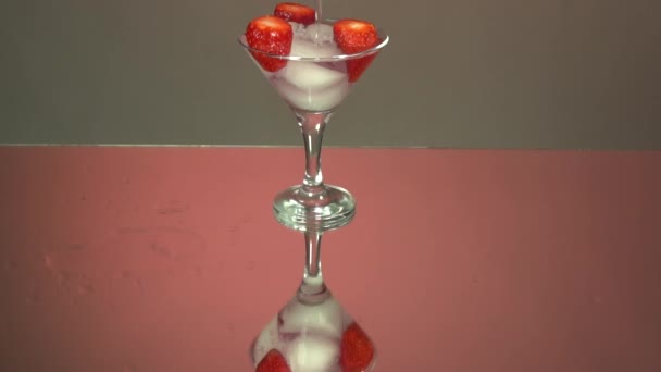 Verser Tequila Dans Verre Glaçons Fraises Ralenti Fond Rose Miroir — Video