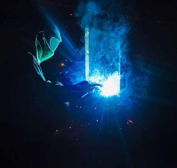 Welder brews metal sparks fly