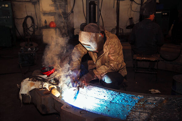 Welder brews metal sparks fly