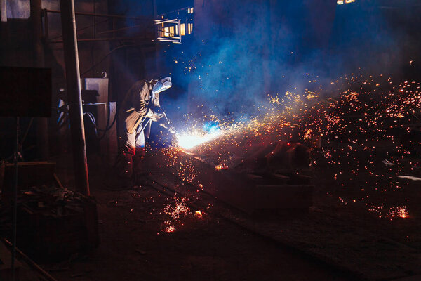 Welder brews metal sparks fly