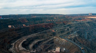 Aerial view of the Iron ore mining, Panorama of an open-cast mine extracting iron ore, preparing for blasting in a quarry mining iron ore, Explosive works on open pit clipart