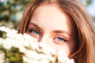 Baharda açık havada yürüyen uzun saçlı mutlu kız.