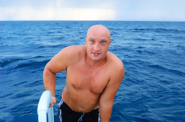 handsome man in the sea on a boat swimming, the concept of recreation and tourism. vacation