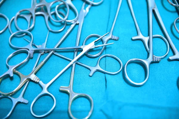 Detail shot of steralized surgery instruments with a hand grabbing a tool — Stock Photo, Image