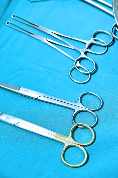 Detail shot of steralized surgery instruments with a hand grabbing a tool — Stock Photo, Image