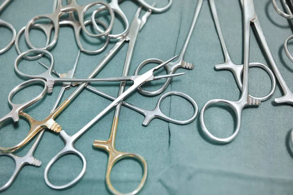 Detail shot of steralized surgery instruments with a hand grabbing a tool — Stock Photo, Image