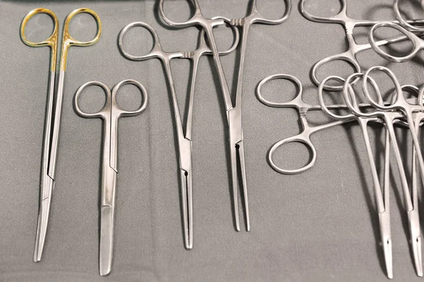 Detail shot of steralized surgery instruments with a hand grabbing a tool — Stock Photo, Image