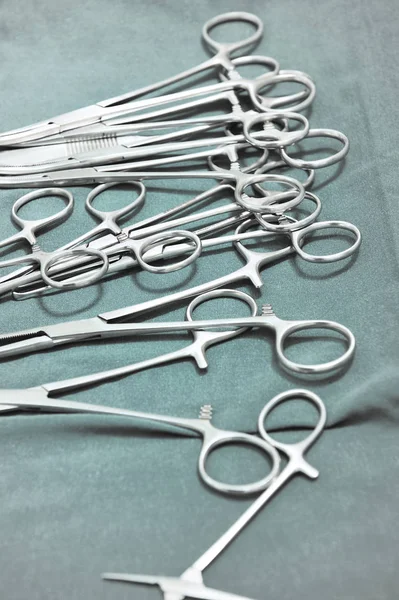 Detalhe tiro de instrumentos de cirurgia esterilizados com uma mão agarrando uma ferramenta — Fotografia de Stock