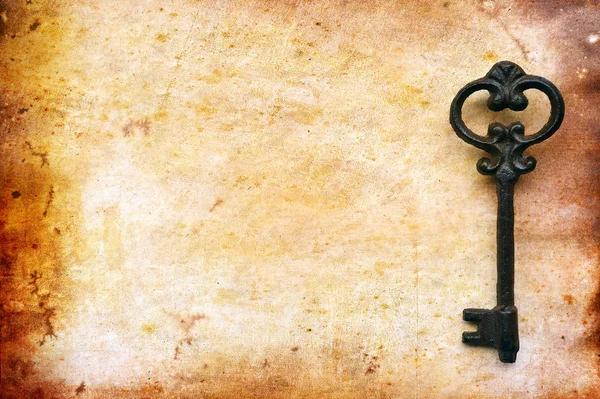 Vintage key on old paper — Stock Photo, Image