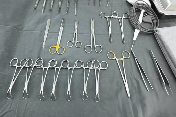 Detail shot of steralized surgery instruments with a hand grabbing a tool — Stock Photo, Image