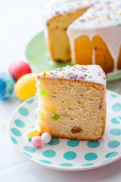 Paskalya masasının arka planında bir tabak kek.