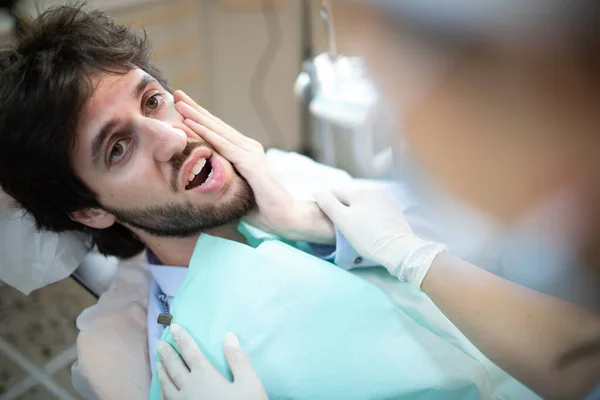 Closeup of dentist treating patient teeth in office.