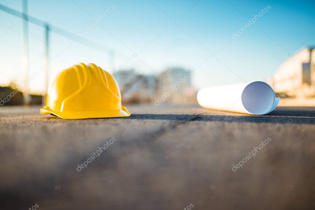 Hard hat with blueprint, building and working concept.