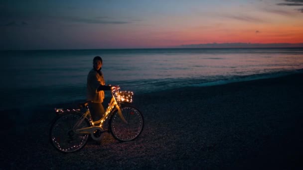 Mulher Desfrutando Pôr Sol Junto Mar Com Guirlanda Bicicleta — Vídeo de Stock