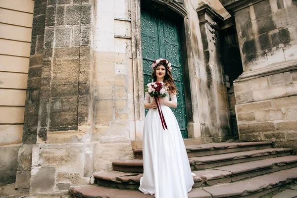 旧市街の教会のステップの花嫁 — ストック写真