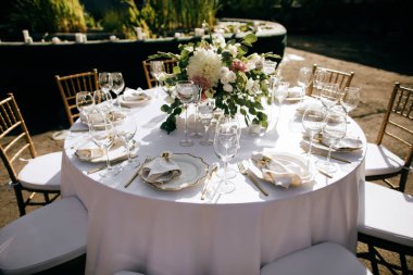 elegant table setting with floral decor in the garden, outdoor catering service