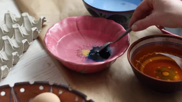 Girl Prepares Blue Paint Painting Easter Eggs — Stock Video