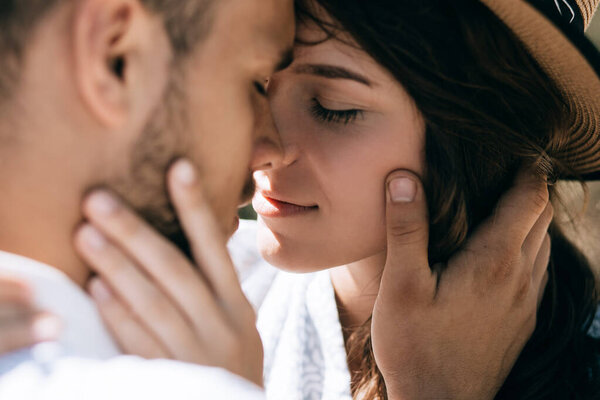 A young couple in love hugs and kisses