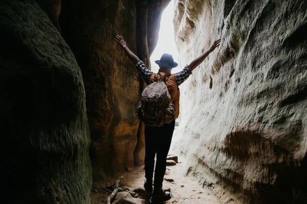 Hiker Man Backpack Stands Cave Standing Arms Outstretched Feeling Positive — Stock Photo, Image