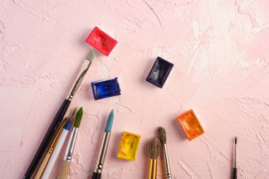 Boya fırçaları, ressam araçları desenli pembe arkaplan, üst görünüm, kopyalama alanı