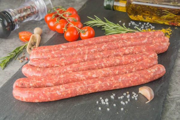 Raw Thin Long Red Sausages Spices Black Slate Hunting Sausages — Stock Photo, Image