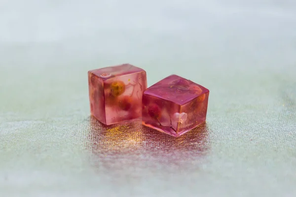 two pink crystals made of epoxy resin