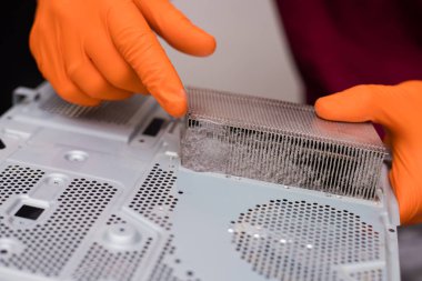 SAINT-PETERSBURG, RUSSIA, OCTOBER 27 2019: Dust inside a disassembled console PlayStation 4 Pro. Close-up, shallow depth of field