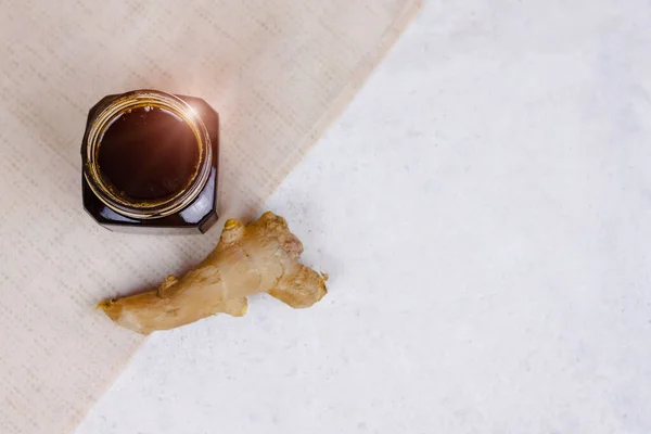 Buckwheat honey and ginger flat lay. Natural medicine, healthy food, ethnoscience, strengthening immunity. Horizontal picture with copy space, close-up, shallow depth of field.