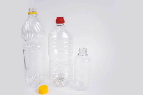 Plastic waste. Bottles and containers. Recycling garbage on white background with copy space. Stop plastic concept. No to plastic. Garbage sorting. Single-use plastic objects. Ecological pollution.
