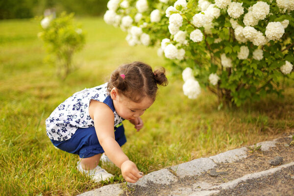 Kazakh curly pretty little girl in the park