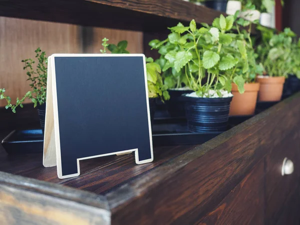 Mock up Chalkboard stand with organic herb plants pot on Wooden shelf — Stock Photo, Image