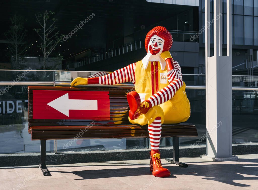 BANGKOK, THAILAND - 10 OCT, 2019 : Mc Donald Mascot Sit on bench Brand Figure shop outdoor