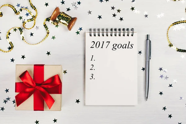 Holiday decorations and notebook with 2017 goals — Stock Photo, Image