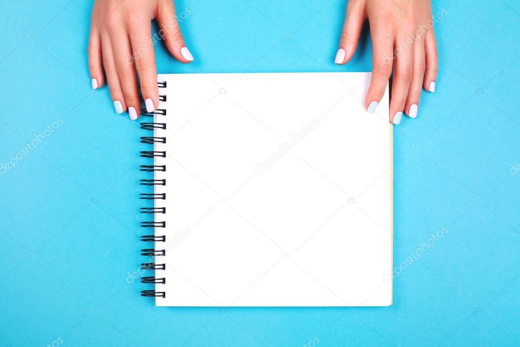 Woman's hands with  notepad